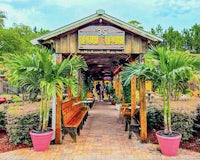 the entrance to a restaurant with palm trees in the background